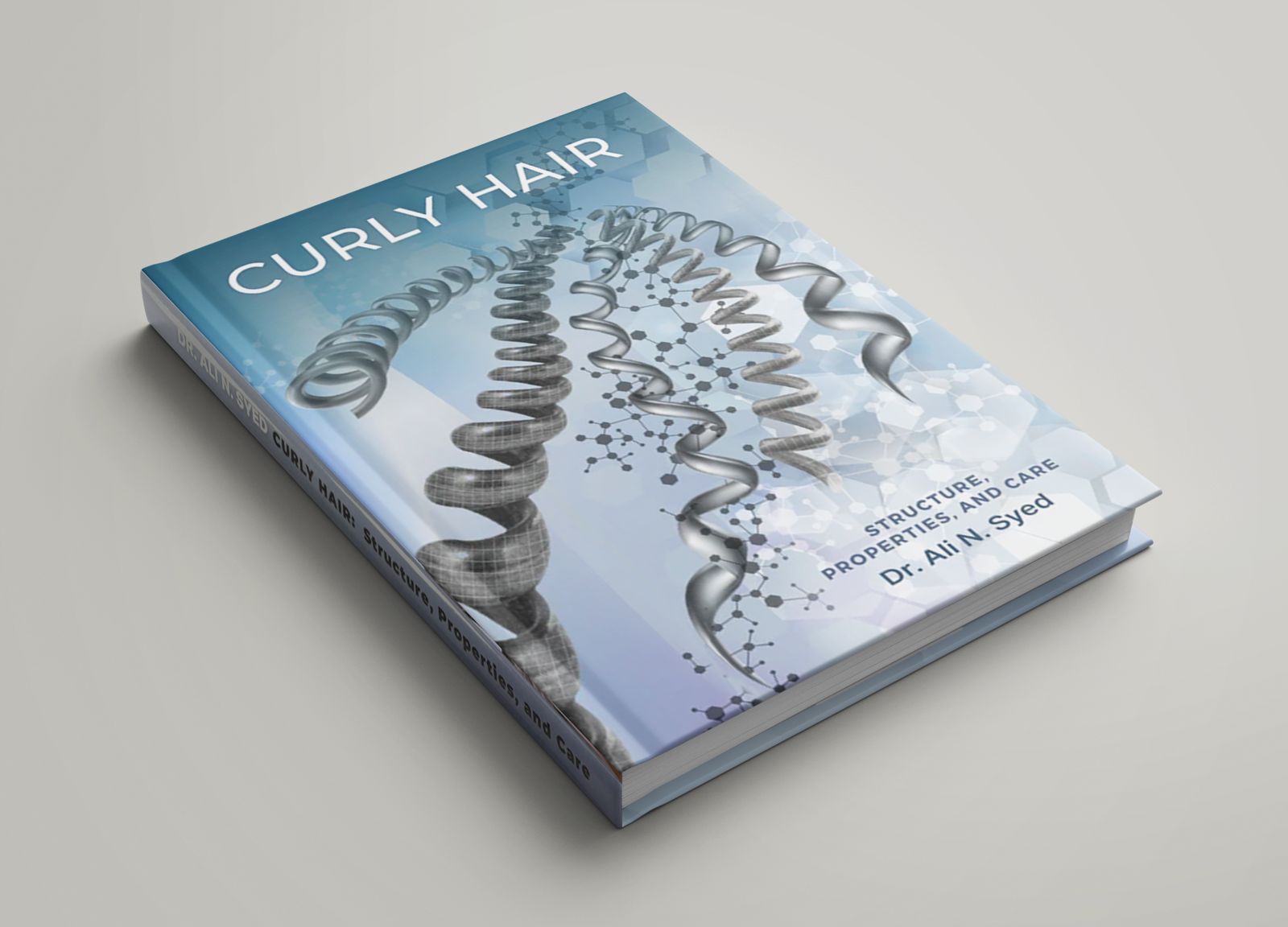 Curly Hair book by Dr. Ali N. Syed featuring scientific illustrations of curly, wavy, and straight hair structures
